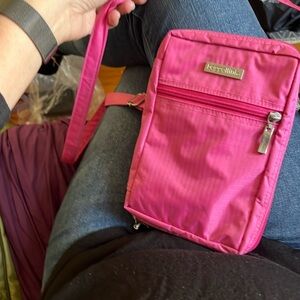 Pink Baggallini long adjustable strap with several compartments inside.